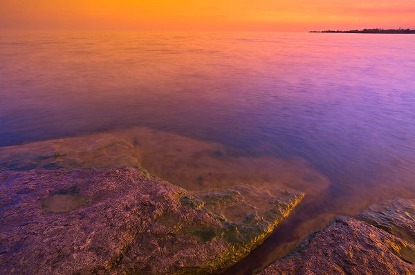 Canada-Ontario-Selkirk Morning light on rocky shoreline of Lake Erie